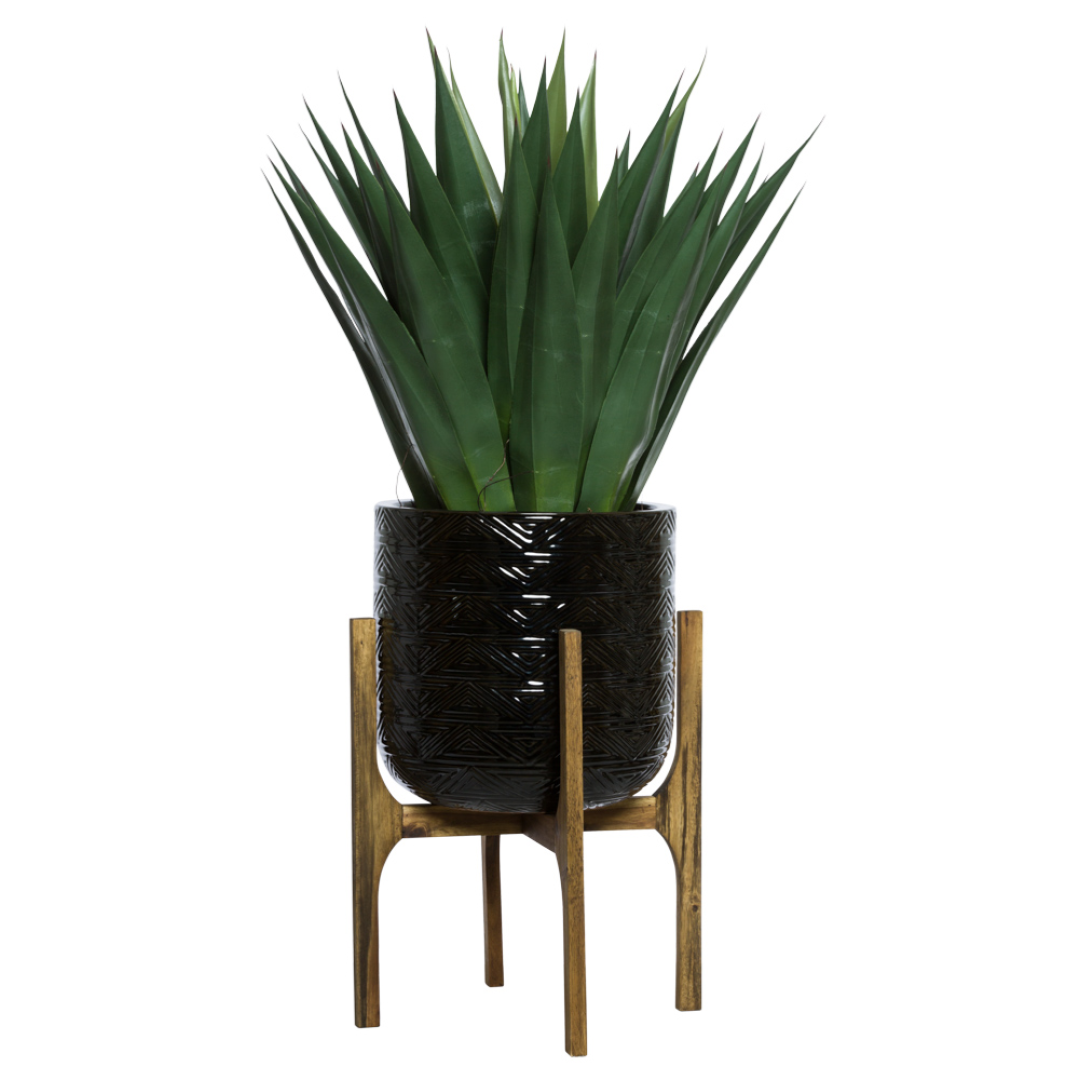Artificial agave plant in a textured black pot on a wooden stand, modern decor
