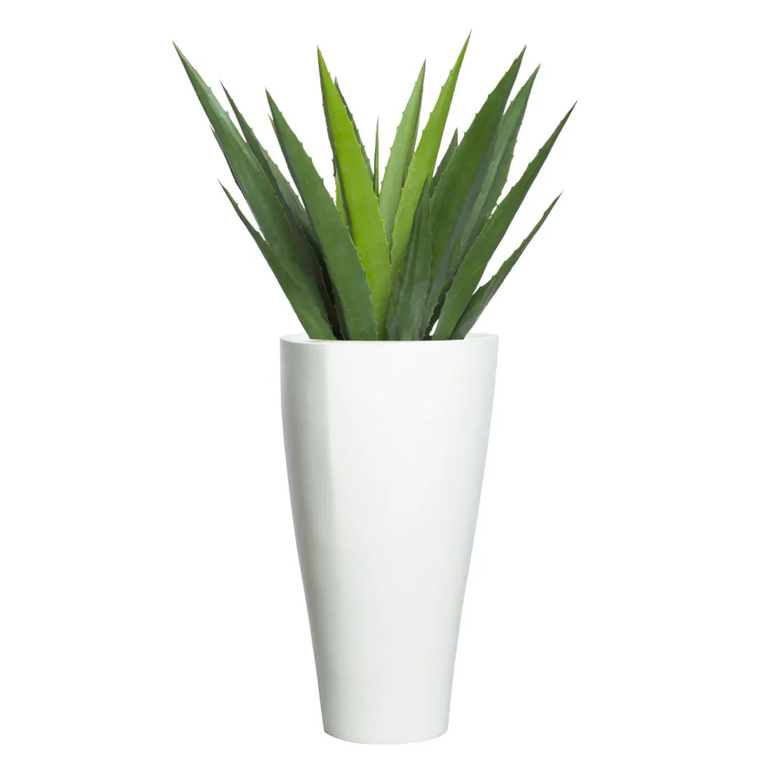 Artificial aloe plant with spiky green leaves in a tall white modern planter