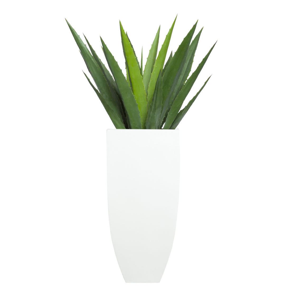 Artificial aloe vera plant in a modern white pot on a white background