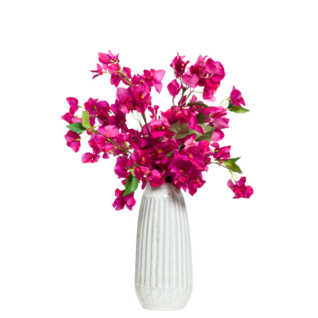 Fuchsia bougainvillea artificial flower arrangement in a tall white ceramic vase