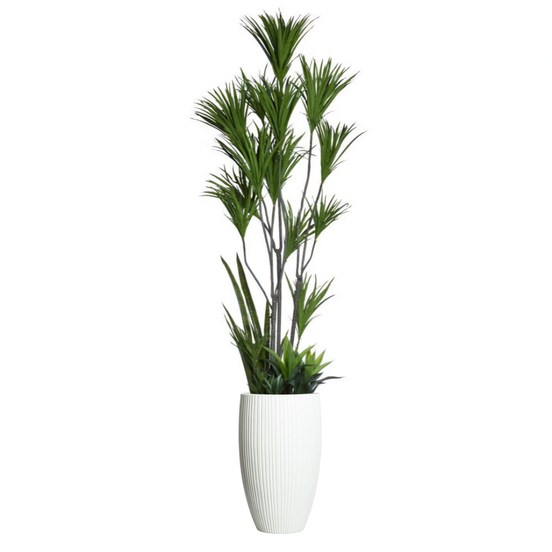 Artificial dracaena plant with tall green leaves in a white textured planter