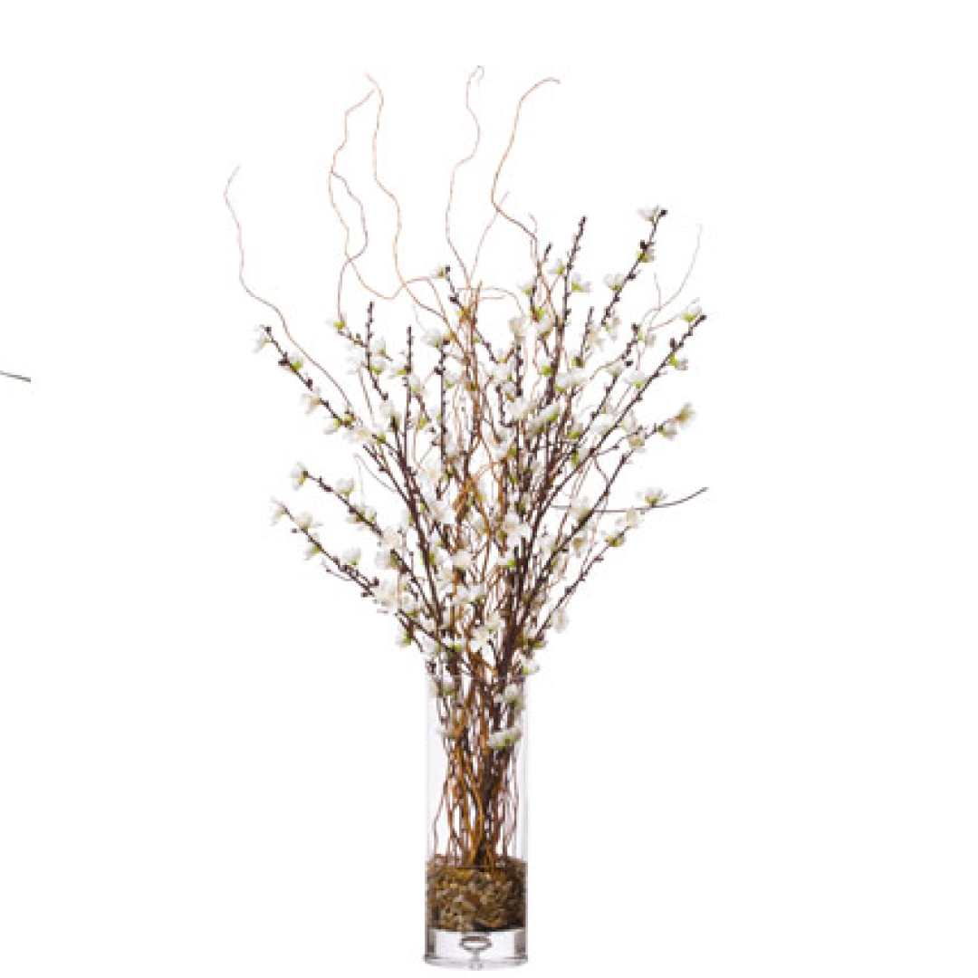 Artificial white plum blossom floral arrangement in tall clear glass vase