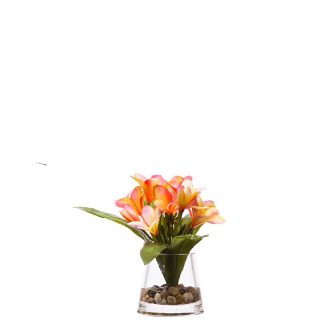 Artificial plumeria flower arrangement in glass vase with pebbles, vibrant orange and pink blooms