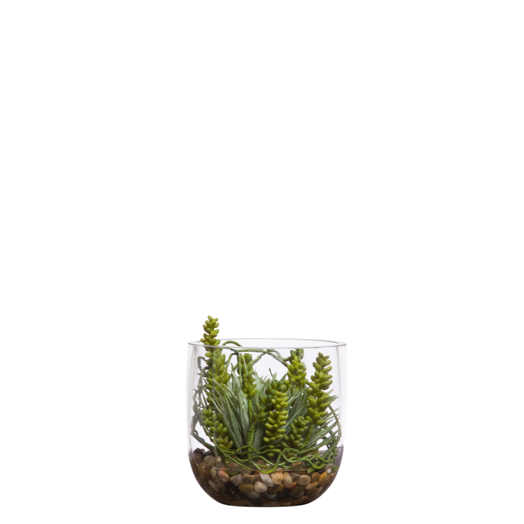 Artificial succulent arrangement in glass vase with decorative stones