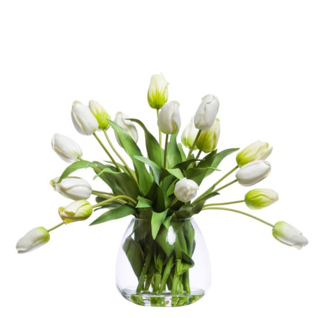 White artificial tulip arrangement in clear glass vase with green leaves