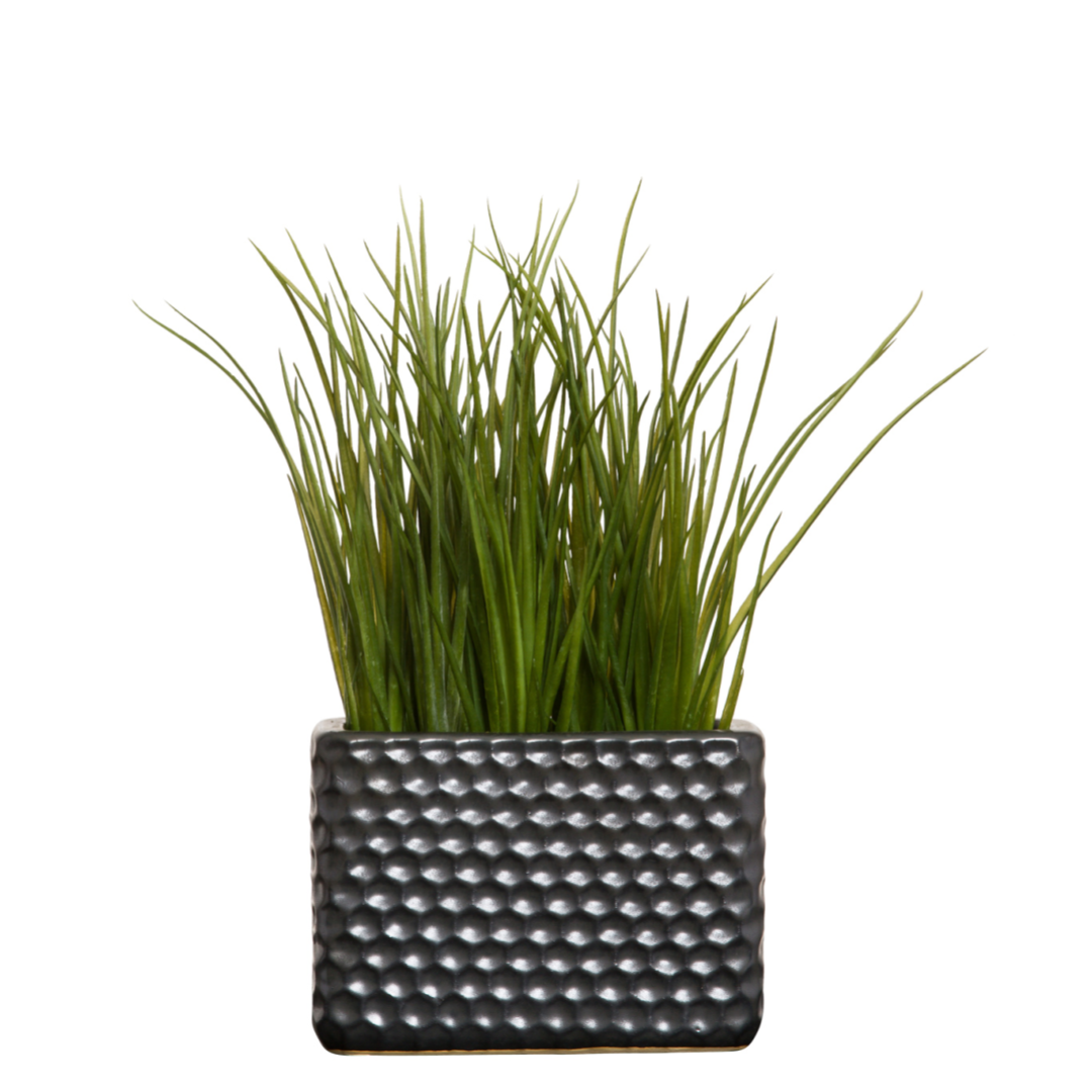 Artificial grass plant in a textured black rectangular planter, modern home decor