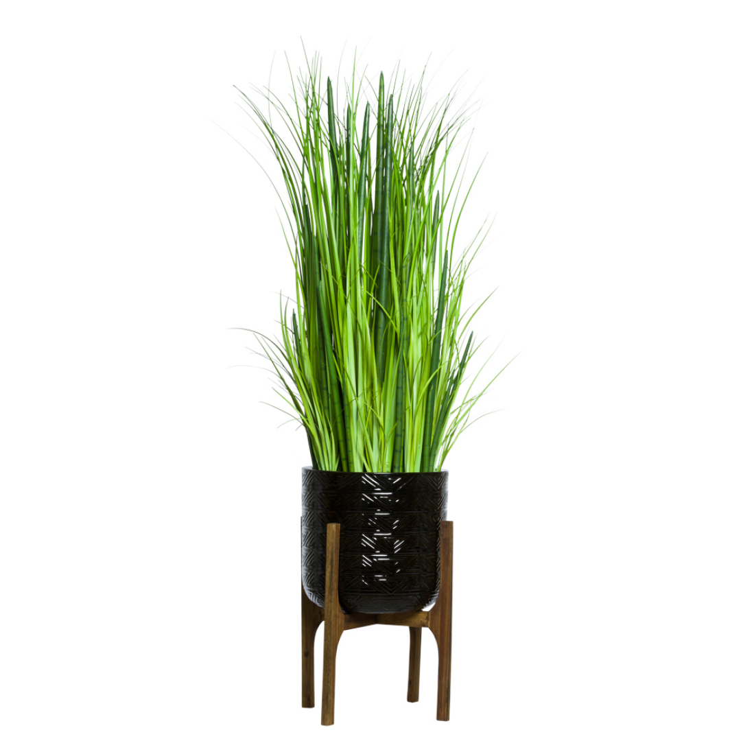 Artificial grass and snake plant mix in black textured planter with wooden stand