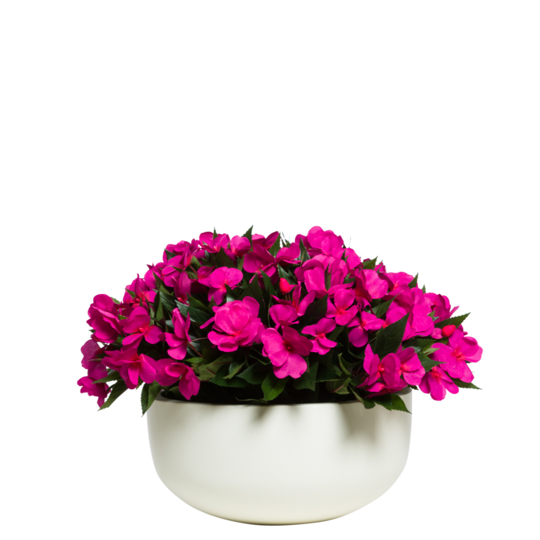 Fuchsia artificial impatiens arrangement in a modern white bowl