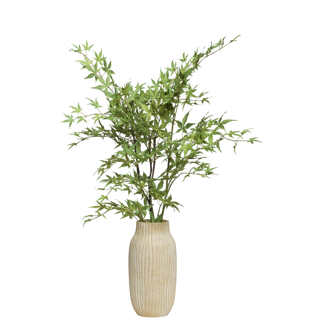 Artificial maple plant with green leaves in a tall beige textured vase