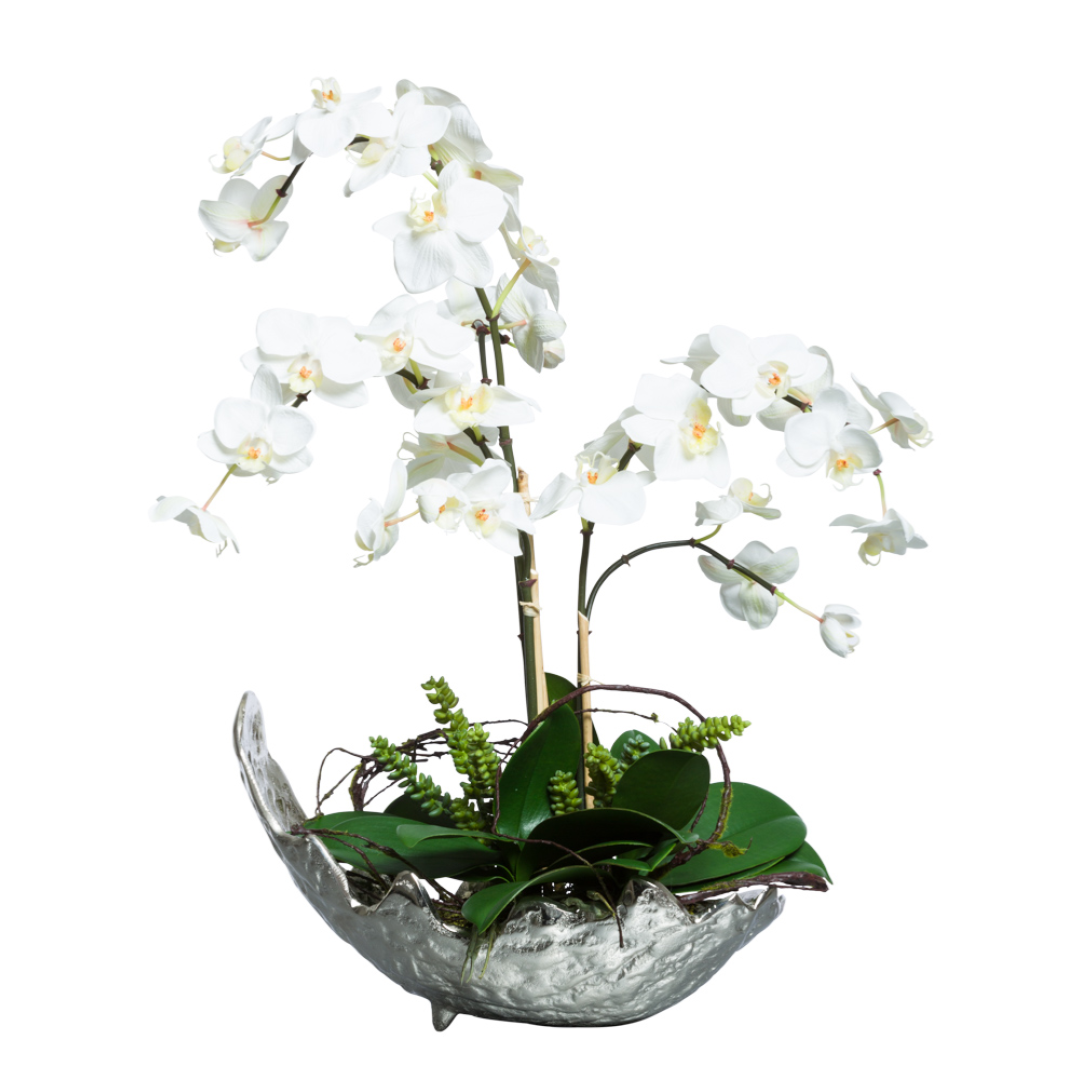 White Phalaenopsis orchid silk arrangement in a textured glass bowl with green foliage