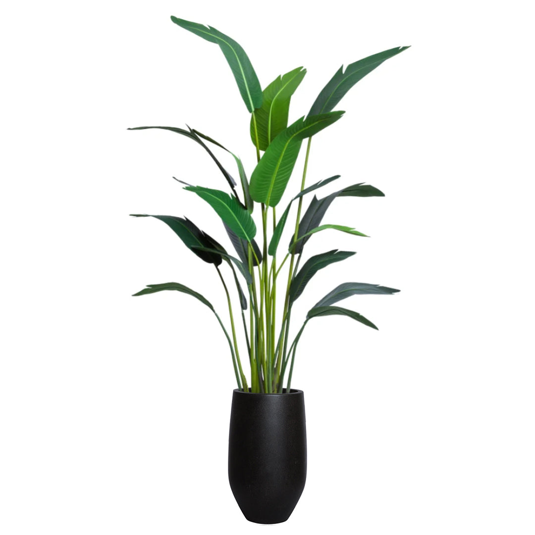 Artificial palm plant with long green leaves in a tall black planter on white background.