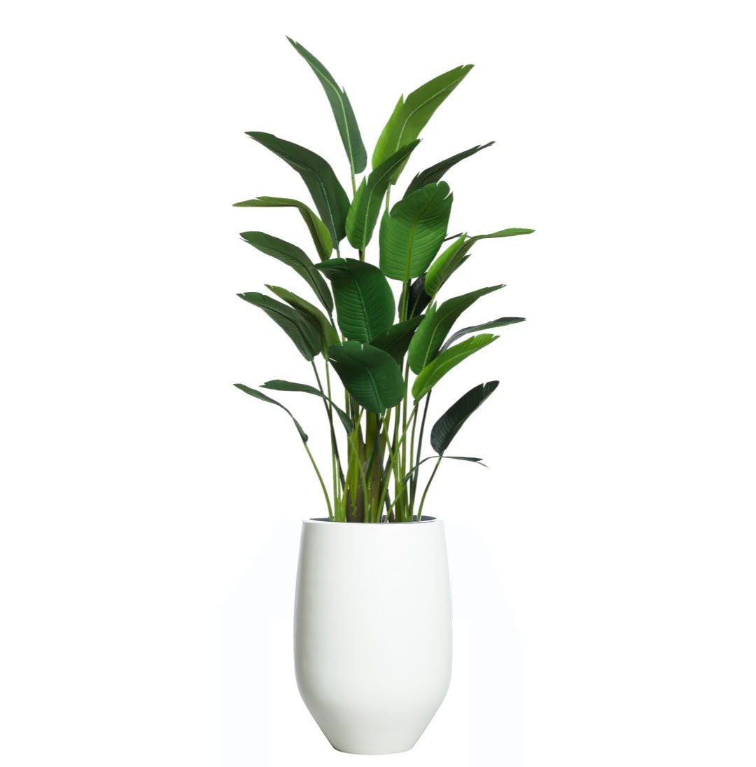 Artificial palm plant with lush green leaves in a modern white planter on white background