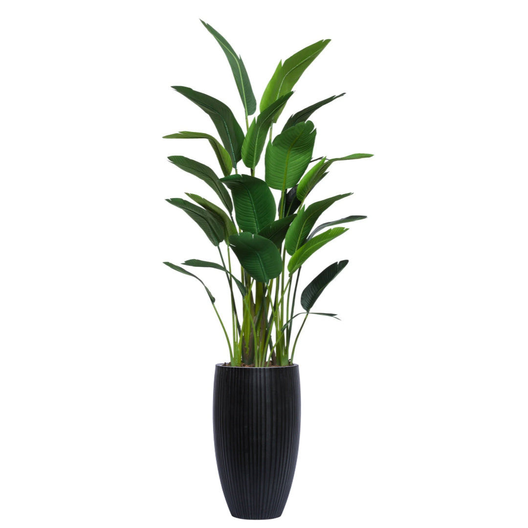Artificial tall potted palm plant with lush green leaves in a black ribbed planter