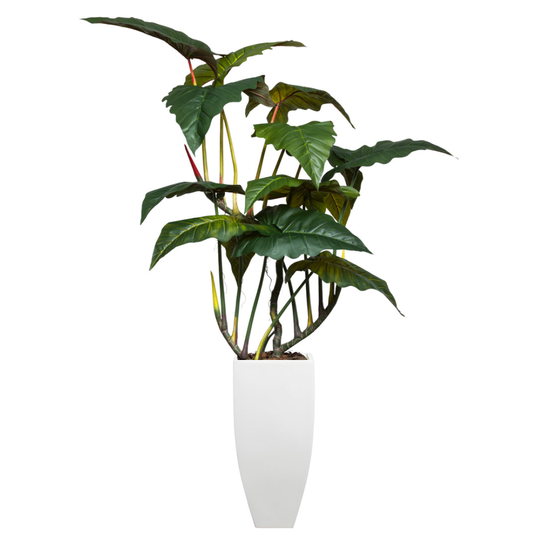 Artificial philodendron plant in tall white square tapered planter with lush green leaves