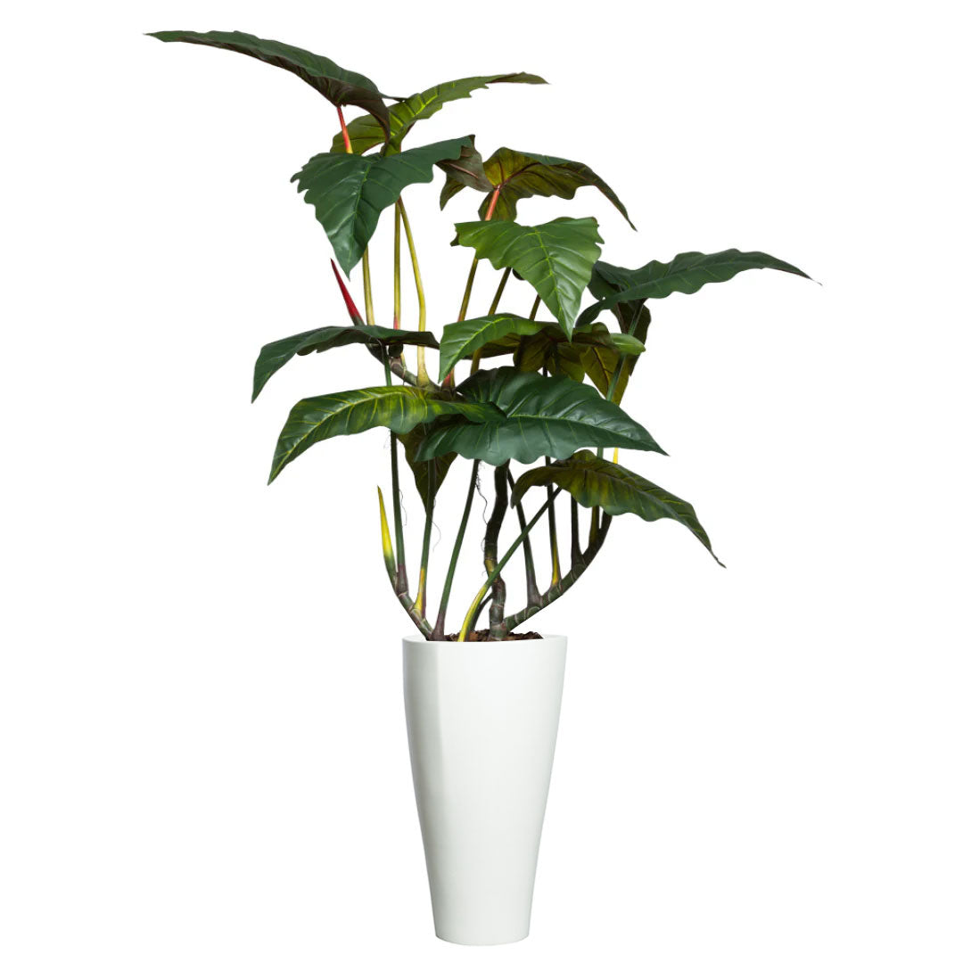 Artificial Philodendron plant with large green leaves in tall white planter on white background
