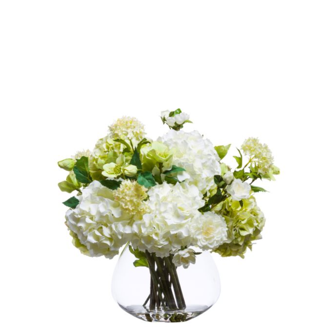 White hydrangeas and roses arrangement in a clear glass vase on white background