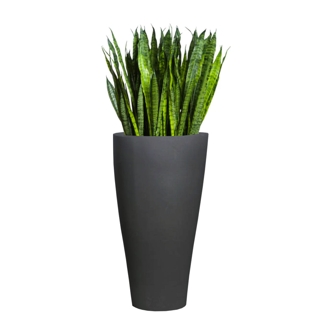 Artificial sansevieria plant with tall green leaves in a modern black planter