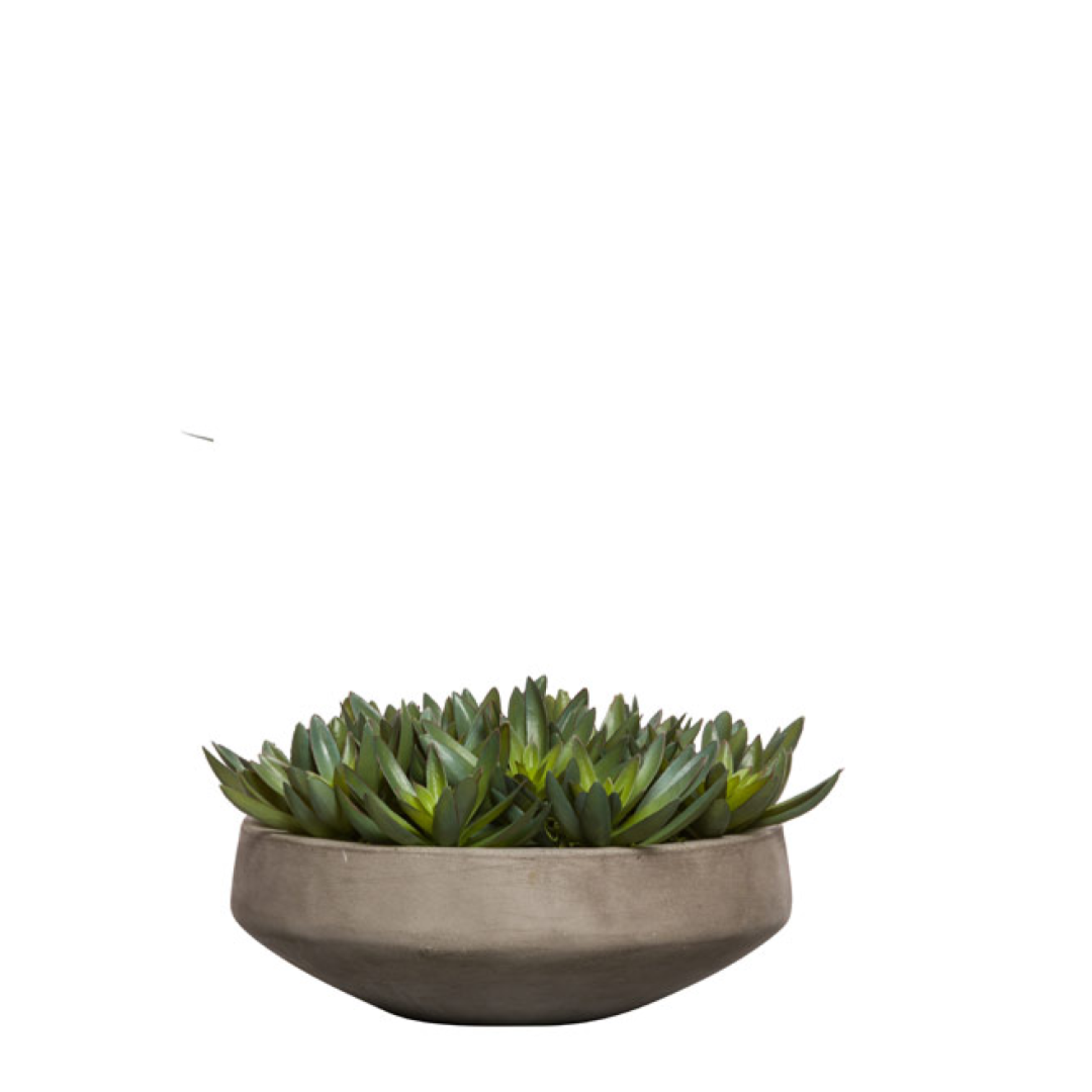 Artificial succulent arrangement in a round gray planter on white background