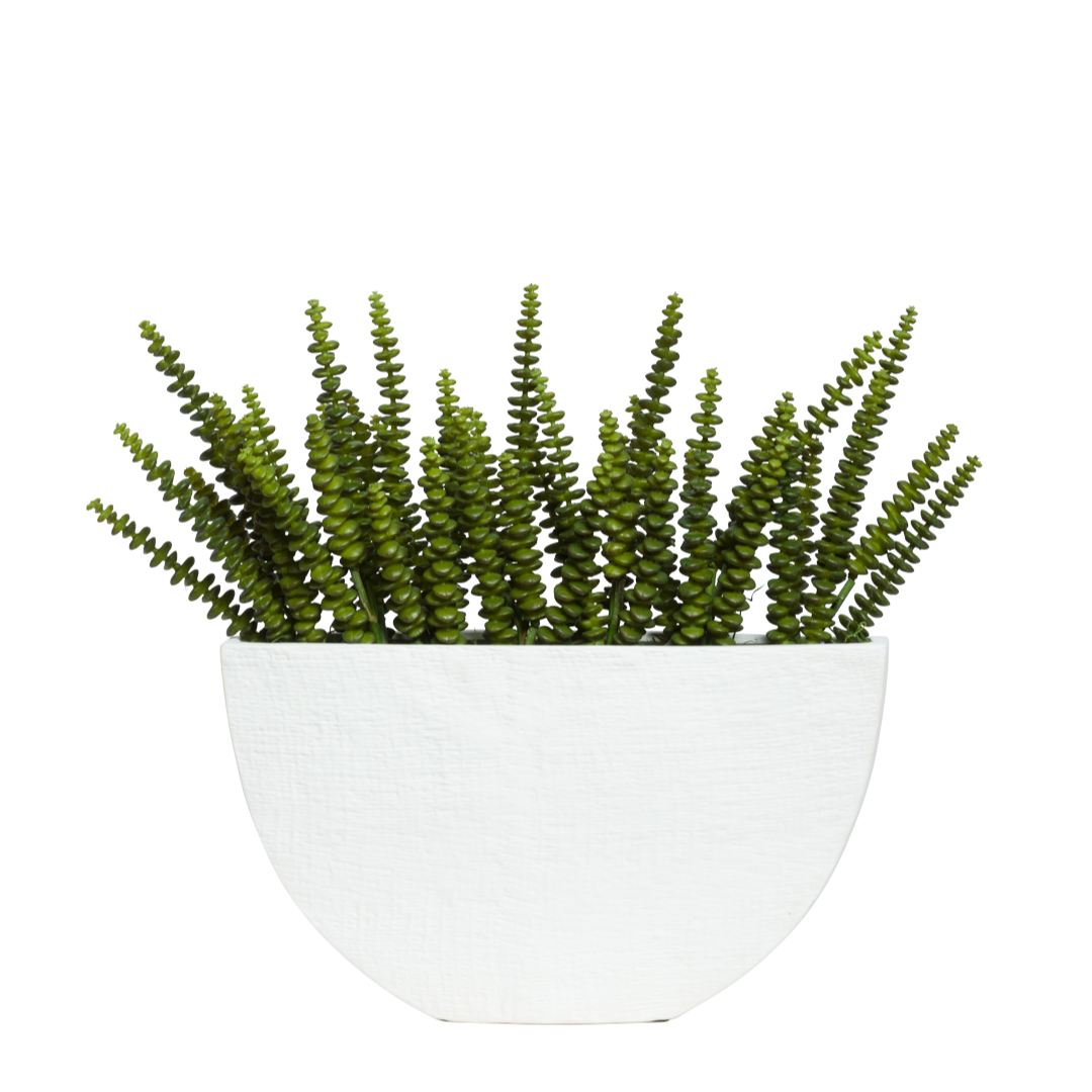 Artificial green succulent arrangement in a modern white textured planter
