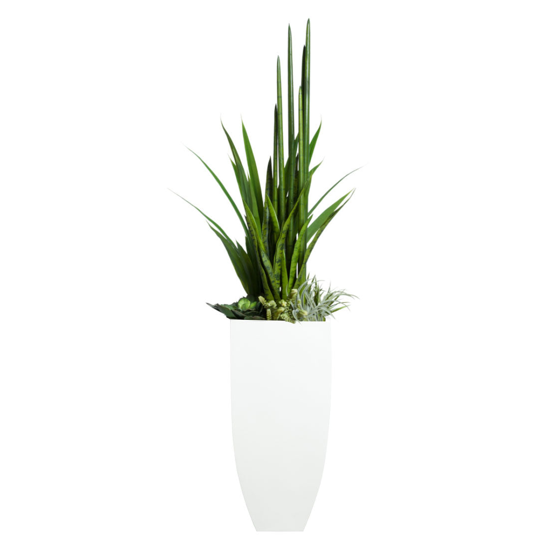Mixed artificial succulents and tall greenery in a modern white planter on white background
