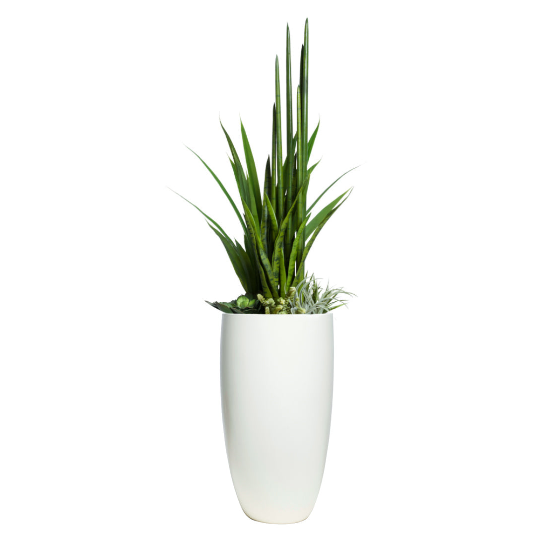 Tall artificial succulent and greenery arrangement in white planter on white background