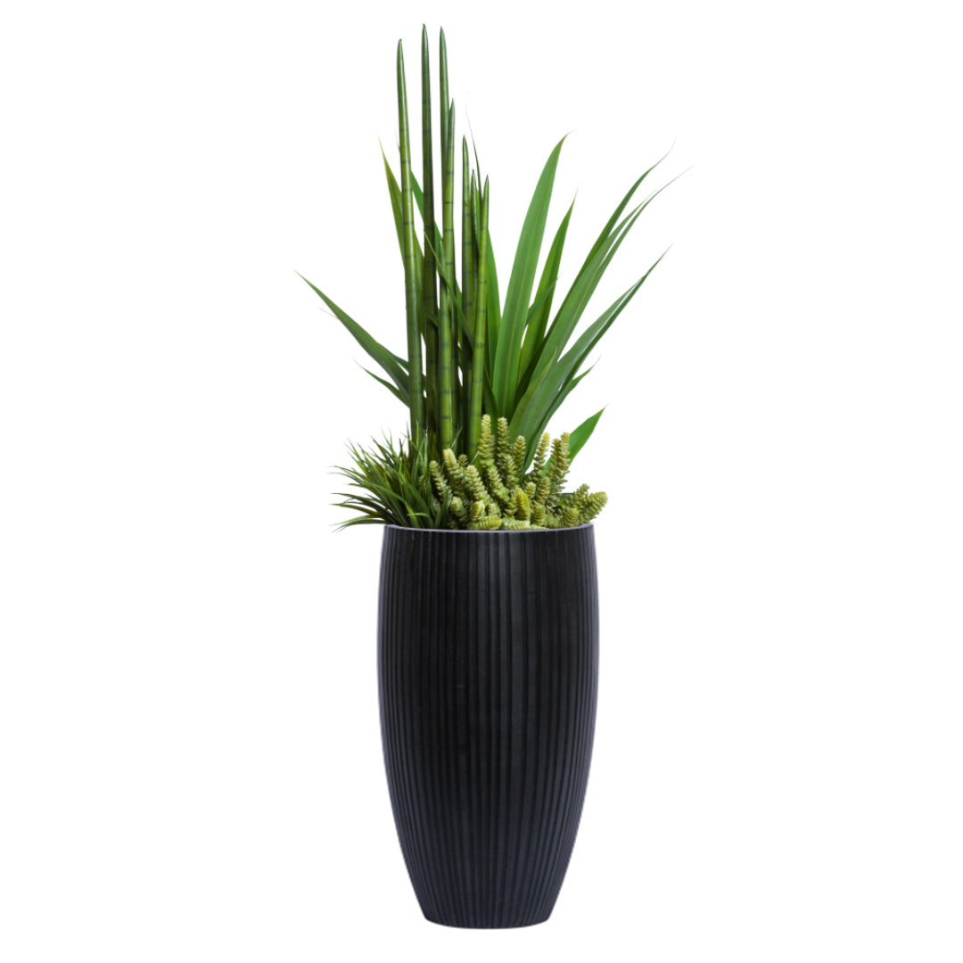 Artificial succulent and greenery arrangement in tall black ribbed planter