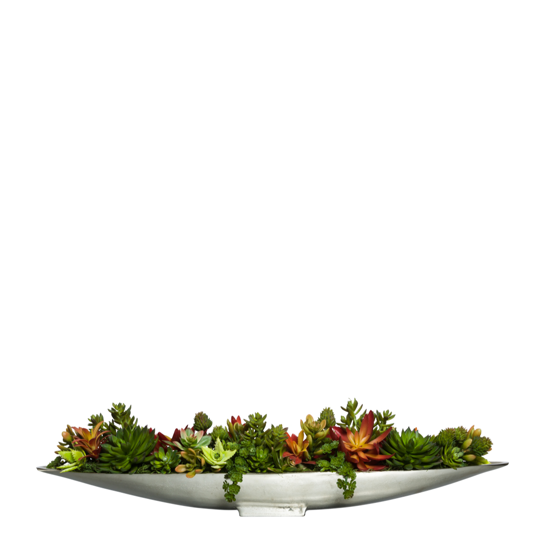 Mixed artificial succulent arrangement in a long silver boat-shaped planter