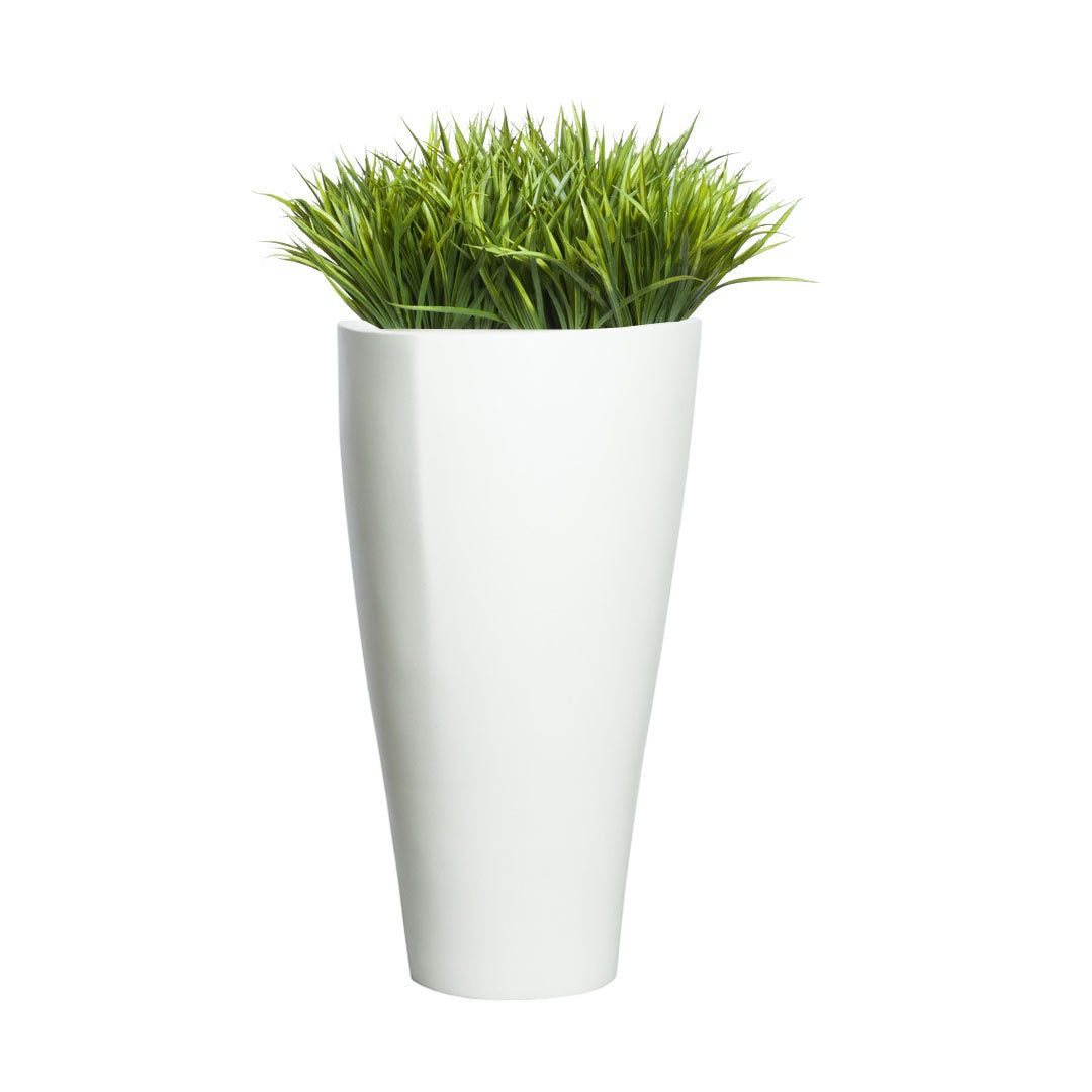 Artificial sword grass in tall modern white planter on white background