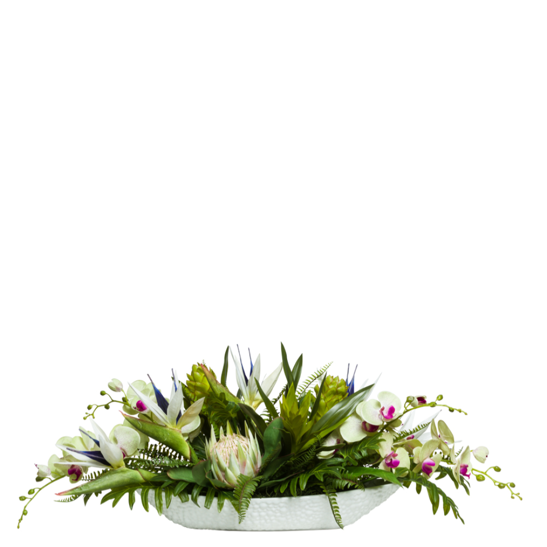 Artificial tropical floral arrangement with orchids, protea, bird of paradise and greenery in a white oval planter