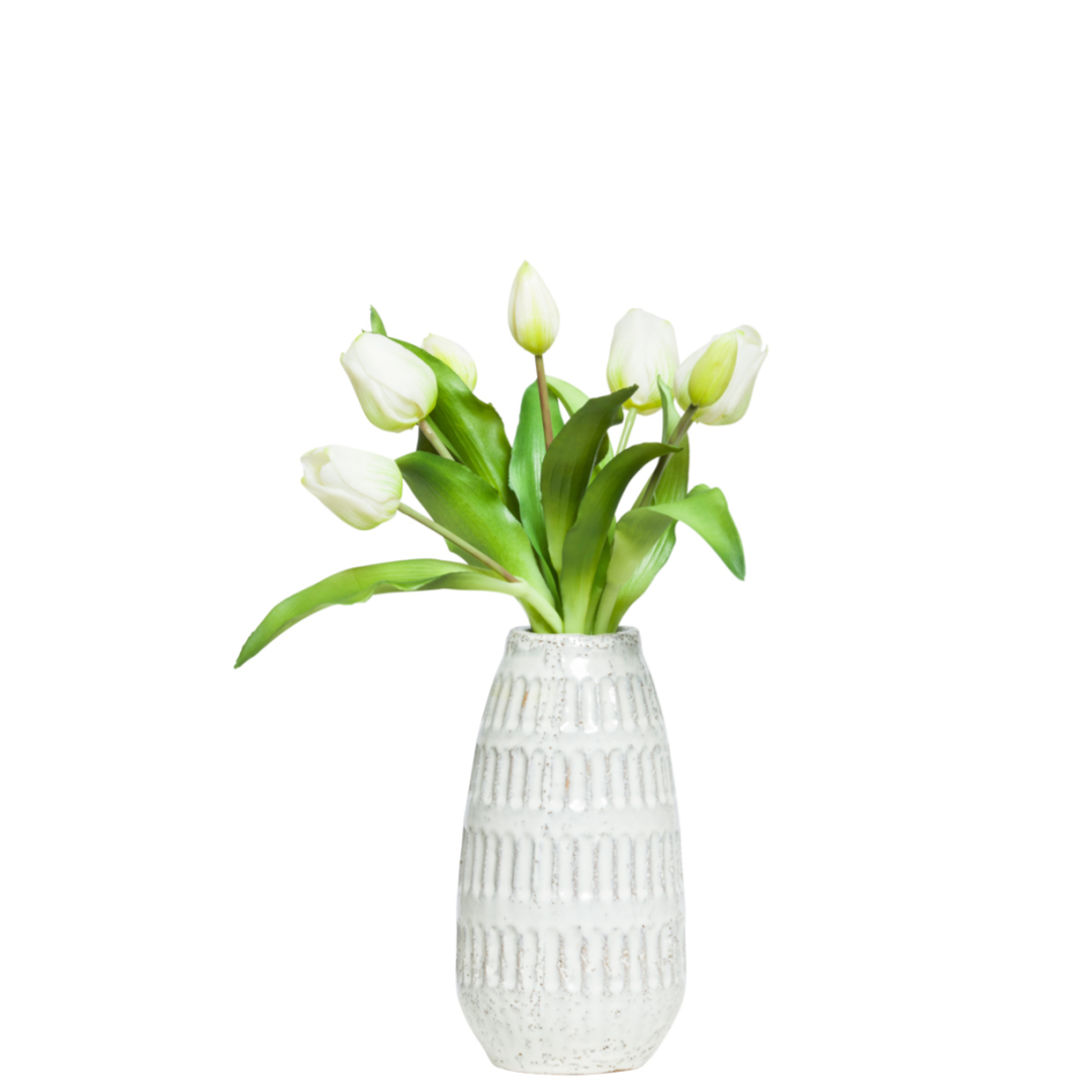 White tulip artificial flower arrangement in textured ceramic vase on white background