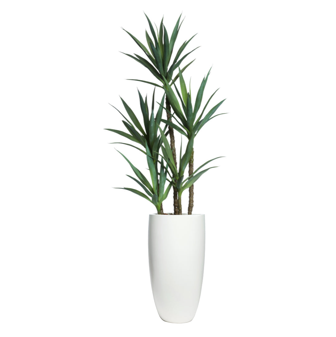 Artificial yucca plant with green leaves in tall white smooth planter
