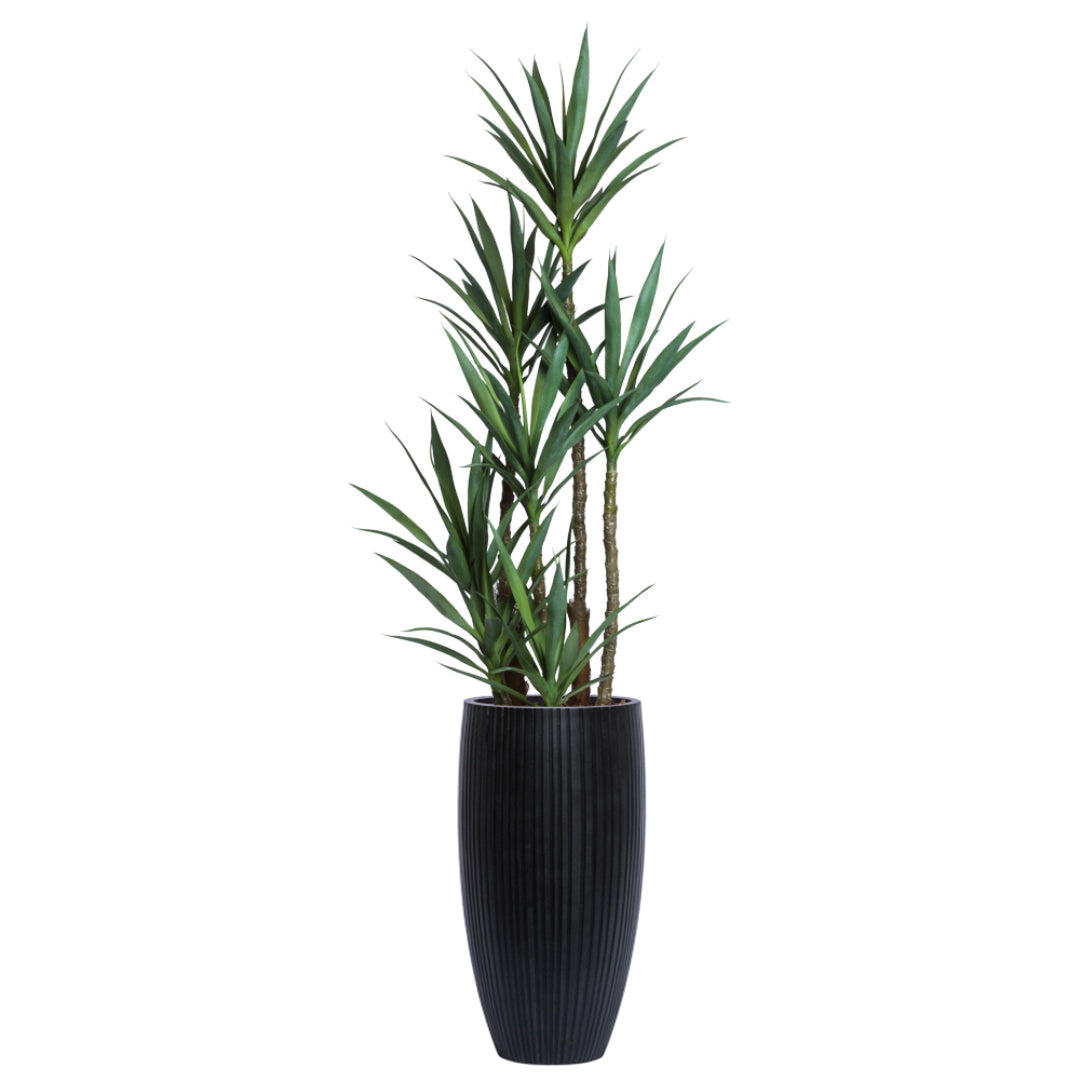 Artificial yucca plant with green leaves in a tall black ribbed planter