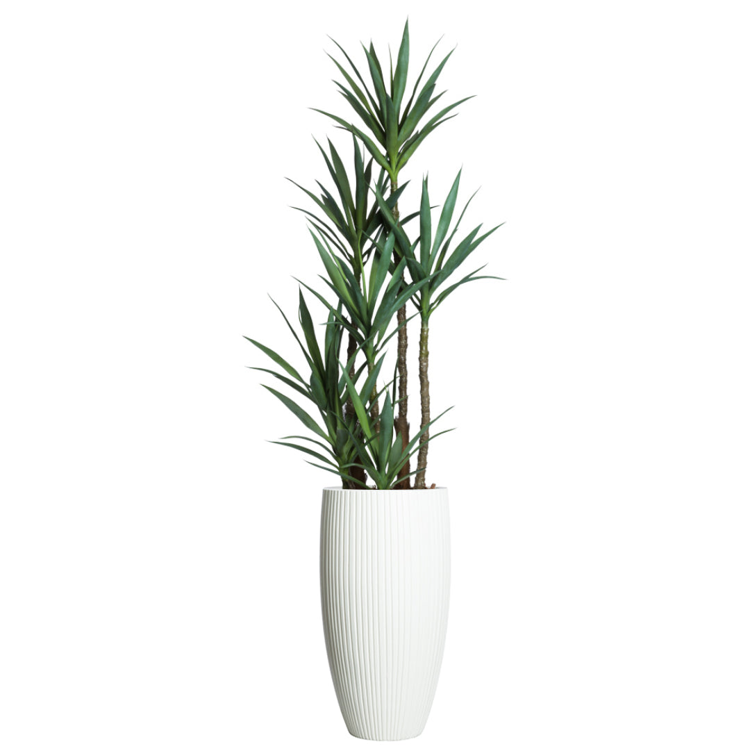 Artificial yucca plant with green leaves in a tall white ribbed planter