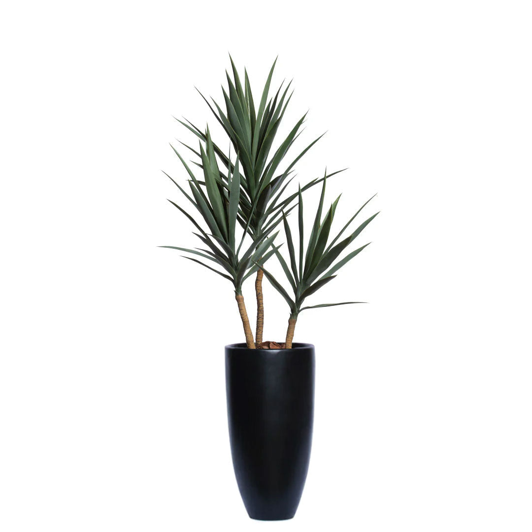 Artificial yucca plant with spiky green leaves in a tall black planter