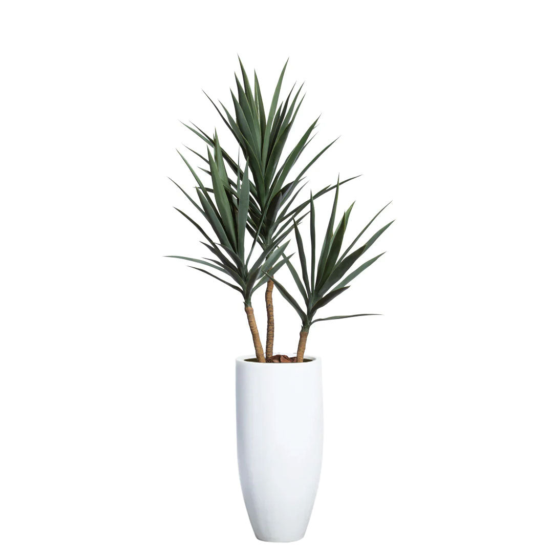 Artificial yucca plant with green leaves in tall white modern planter