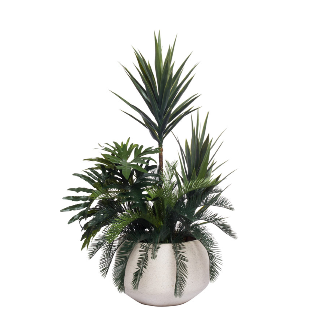 Artificial yucca and tropical greenery in a large round white planter