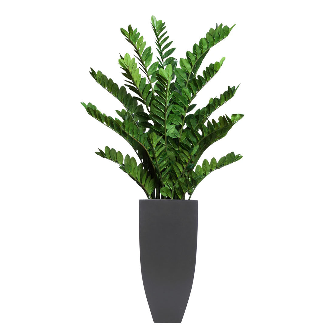 Artificial Zamiifolia plant with glossy green leaves in a modern black planter on white background