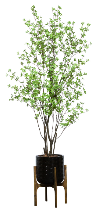Artificial green flowering tree in black textured planter with wooden stand