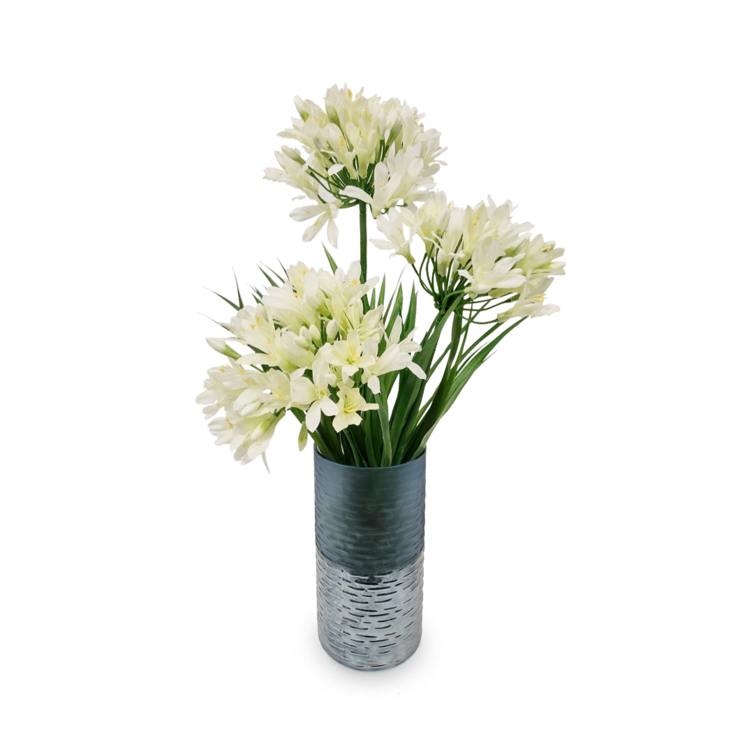White agapanthus artificial flowers arranged in a textured metallic vase on a white background.