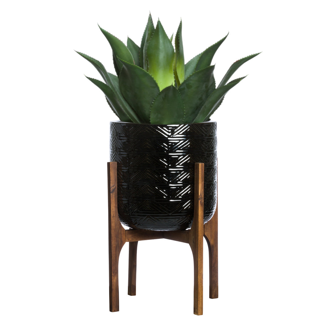 Artificial agave plant in a black textured pot on a wooden stand, modern decor