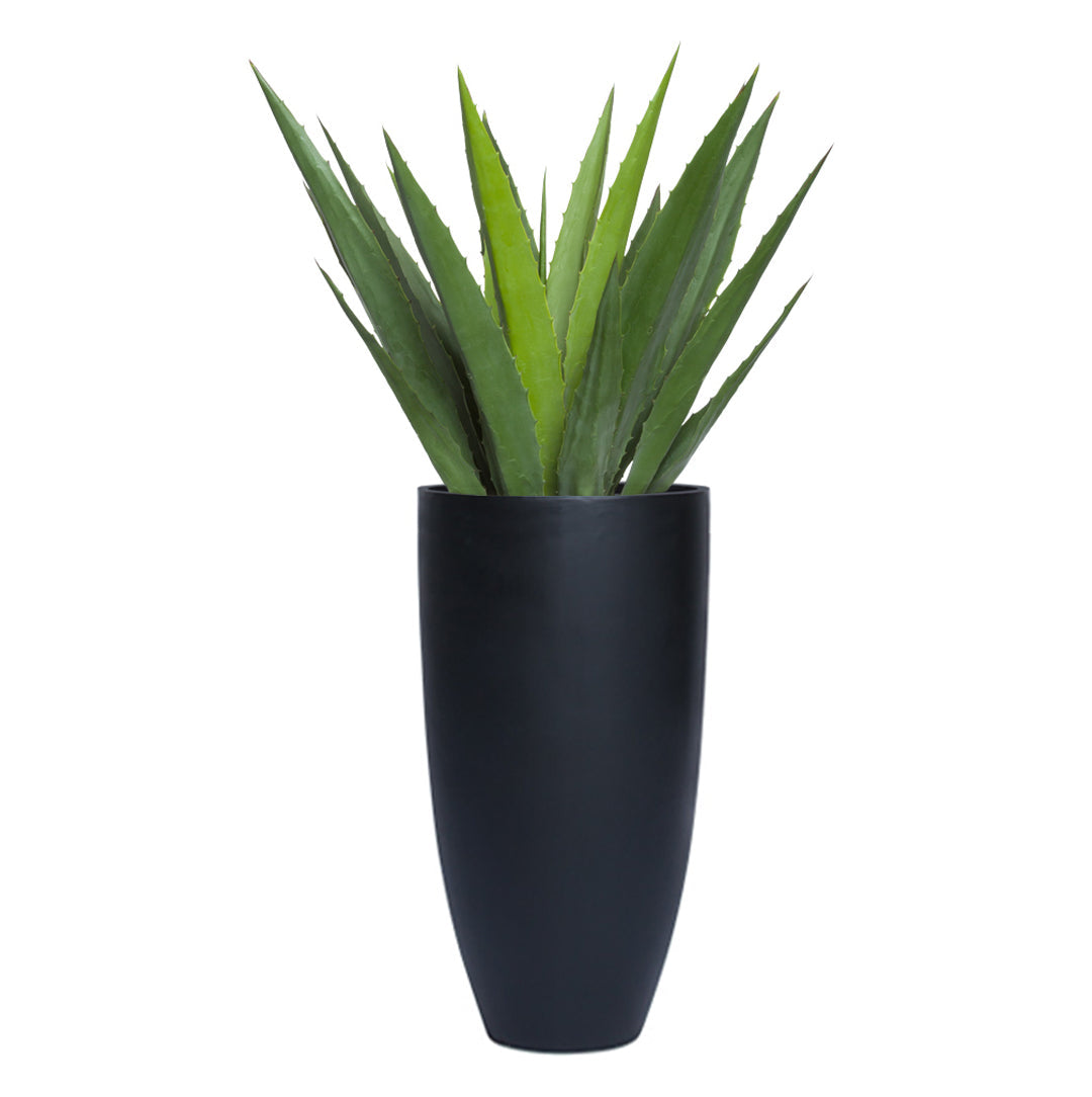 Artificial aloe vera plant in a tall, smooth black planter, modern decor