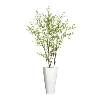 Artificial birch tree with green leaves in a tall white planter, isolated on white background