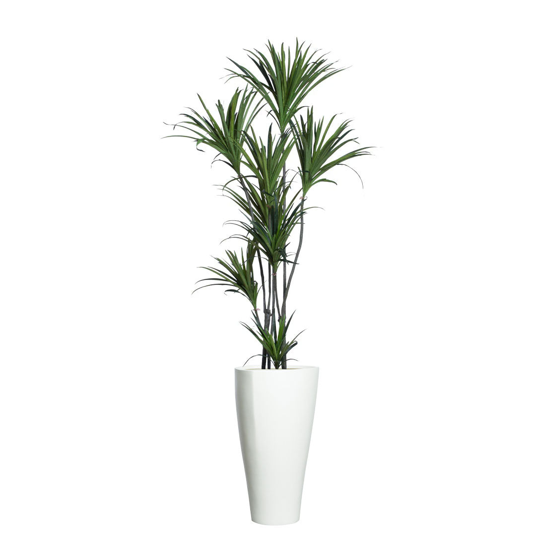 Artificial dracaena plant with long green leaves in a tall white modern planter