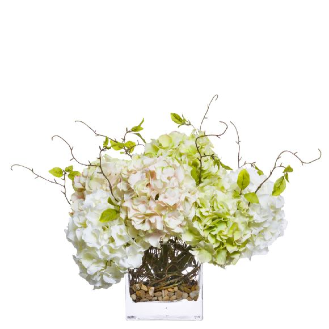 Artificial hydrangea and willow mix arrangement in a clear glass vase with pebbles