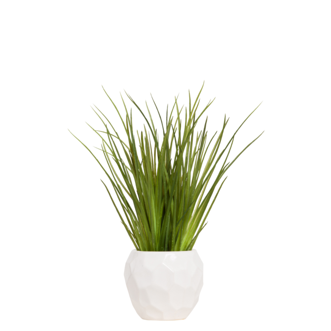 Artificial grass plant in a geometric white pot, realistic faux greenery decor