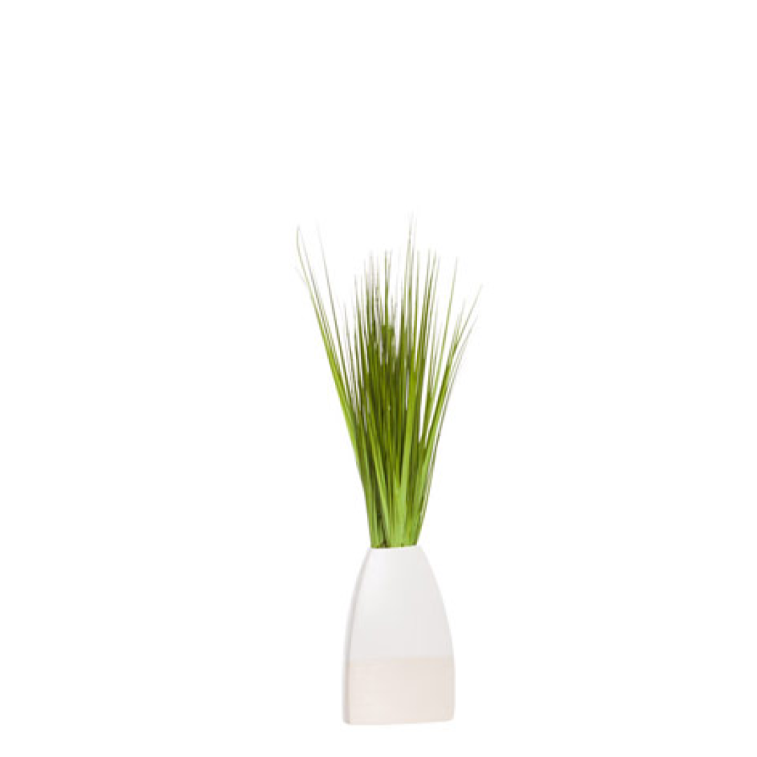 Artificial green grass arrangement in a modern white ceramic vase on white background