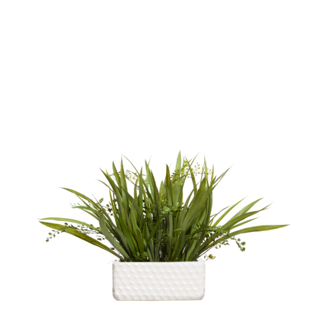 Lifelike artificial green grass and fern in a textured white ceramic planter