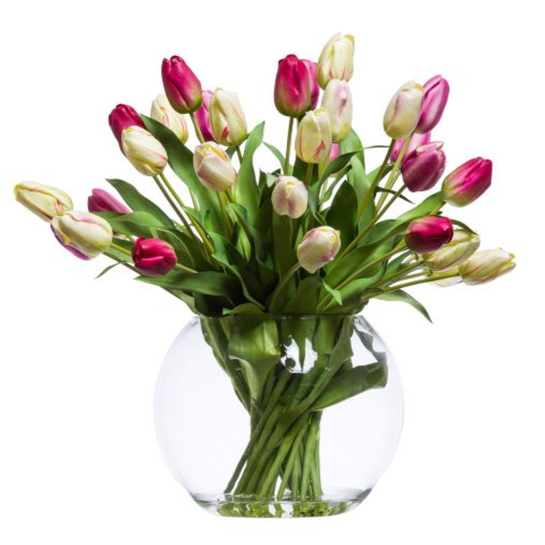 Pink and white artificial tulips arranged in a clear round glass vase