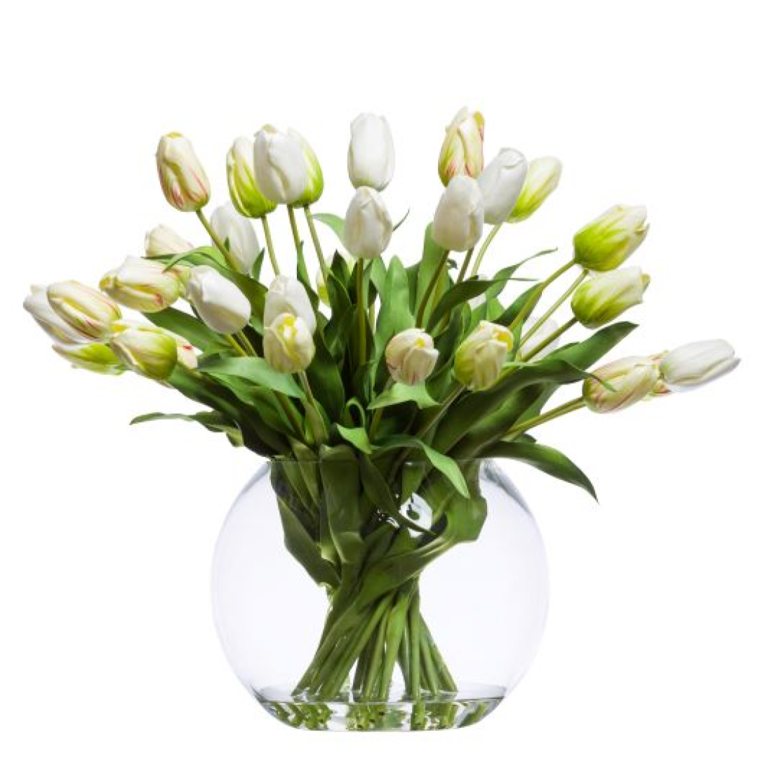 White tulip arrangement with green leaves in a clear round glass vase