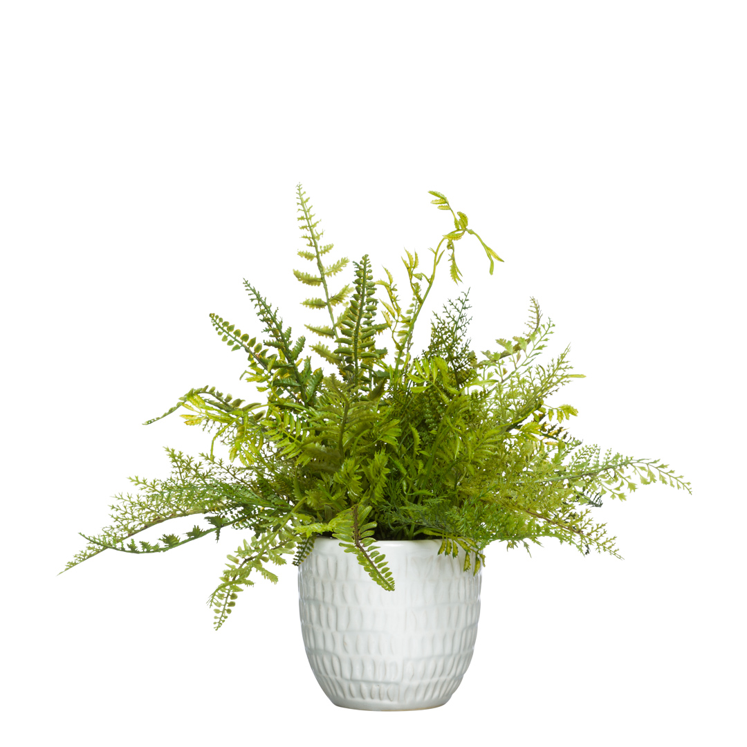 Artificial greenery arrangement in a textured white ceramic pot on white background
